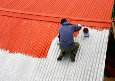 Tôles d'un hangar agricole peintes en rouge orangé